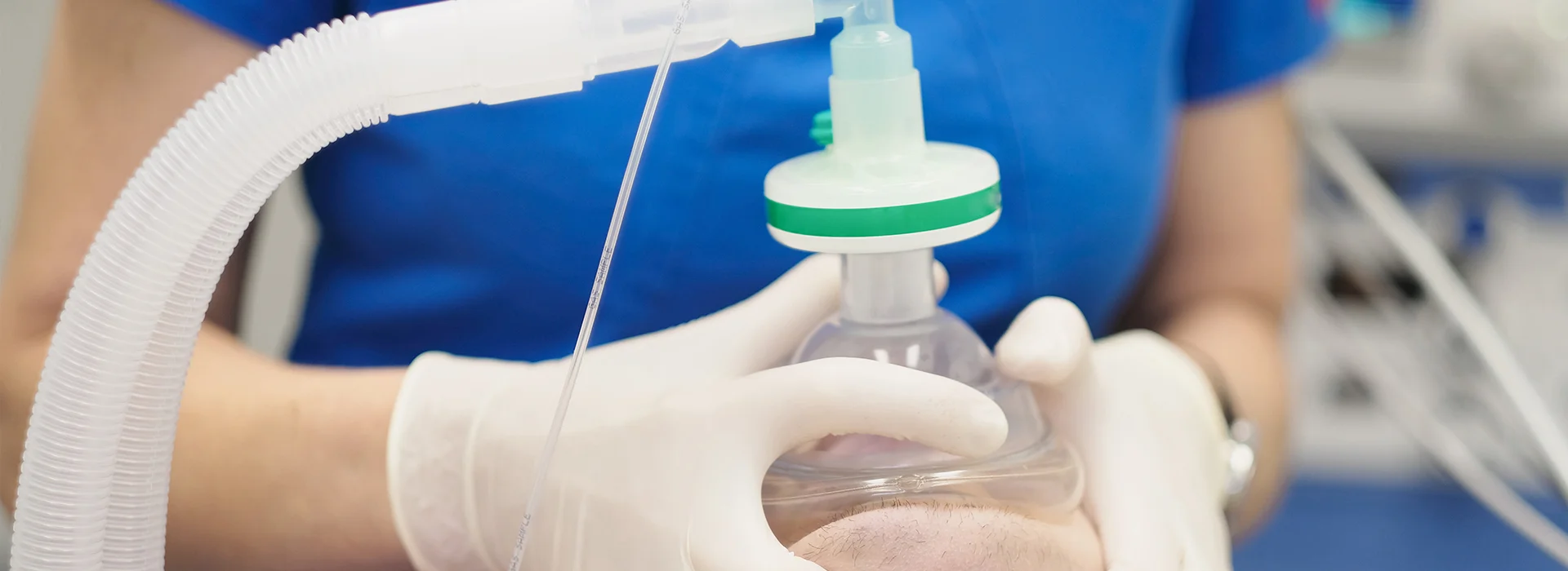 Photo of gloved provider holding sedation mask for sedation dentistry Queens