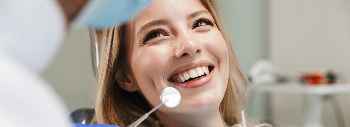 Dentist applying dental sealants in a modern dental office