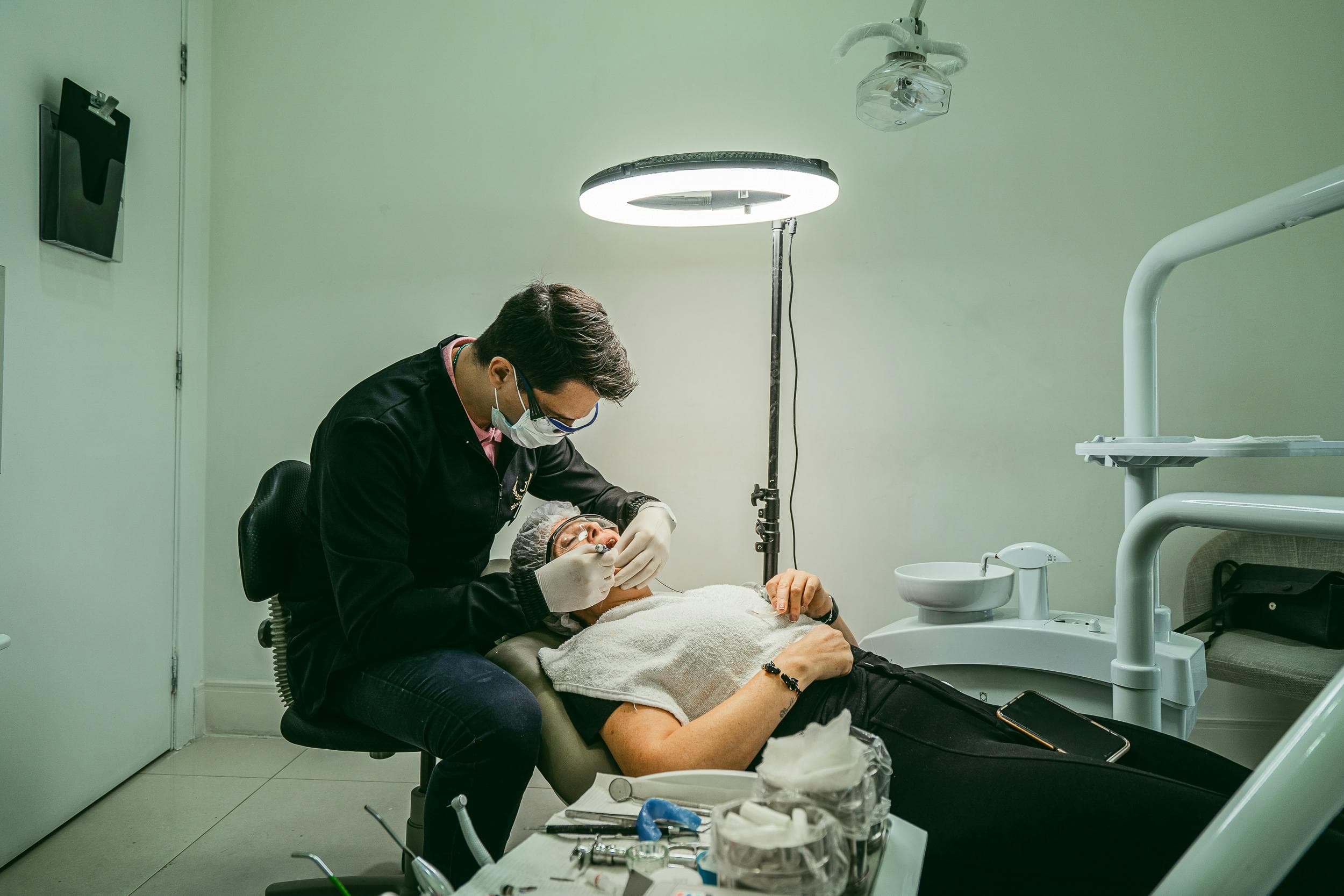 How Much Is An Emergency Dentist Dentist Working On Patient Under Bright Light In Modern Treatment Room