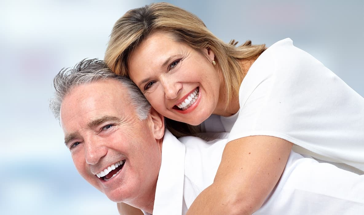 Photo Smiling Middle Aged Couple Embracing And Showing Bright Teeth Representing Long Term Benefits Dental Implants On Light Blue Background