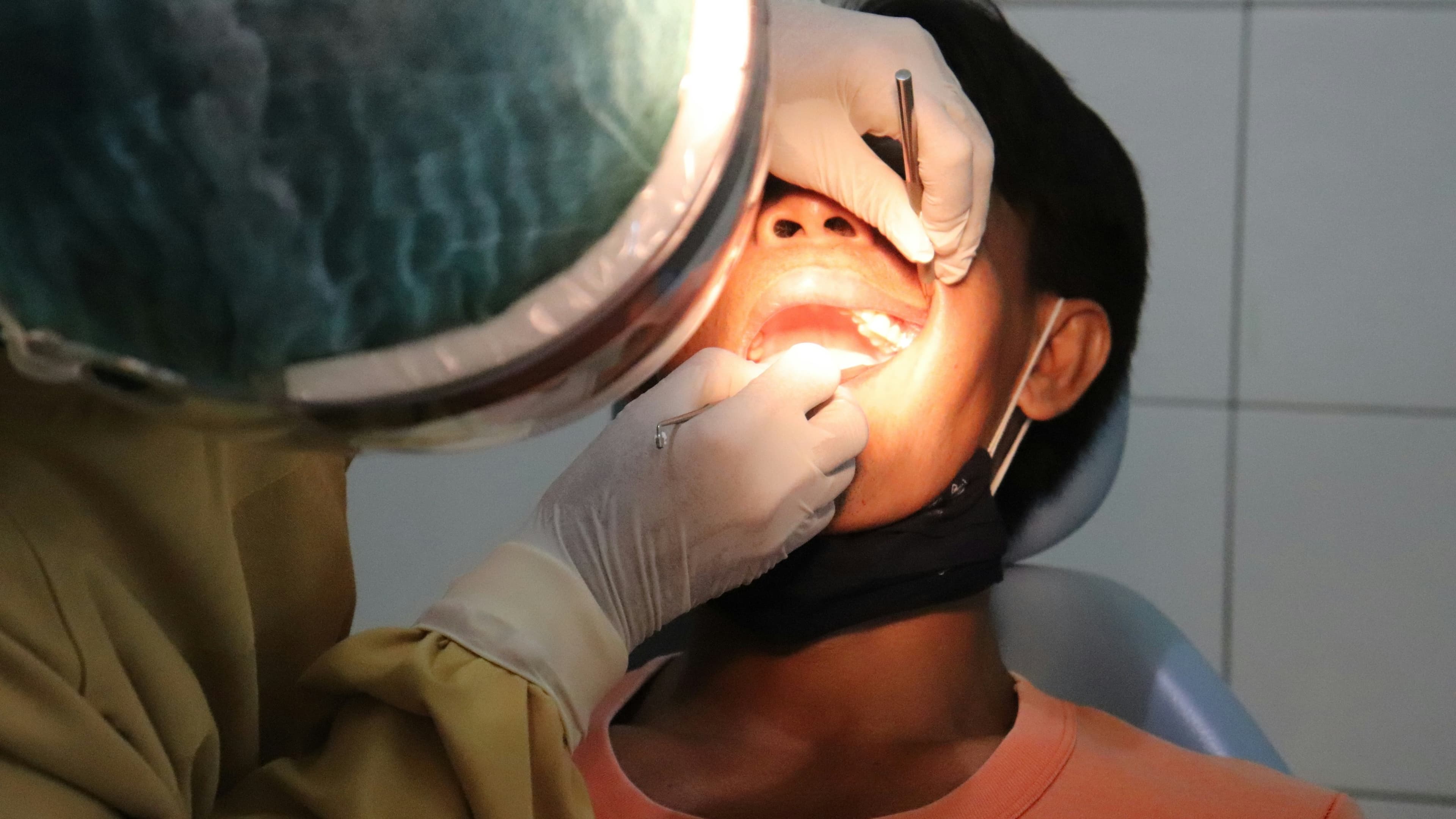 Photo Patient Examined In Chair Am I A Candidate For Dental Implants