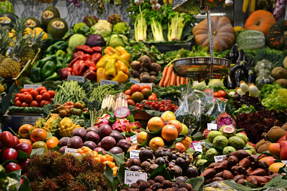 Colorful Market Display Of Fruits And Vegetables Including Options Like Avocados Bananas And Squash Which Are Part Of The 50 Soft Foods To Eat After Tooth Extraction